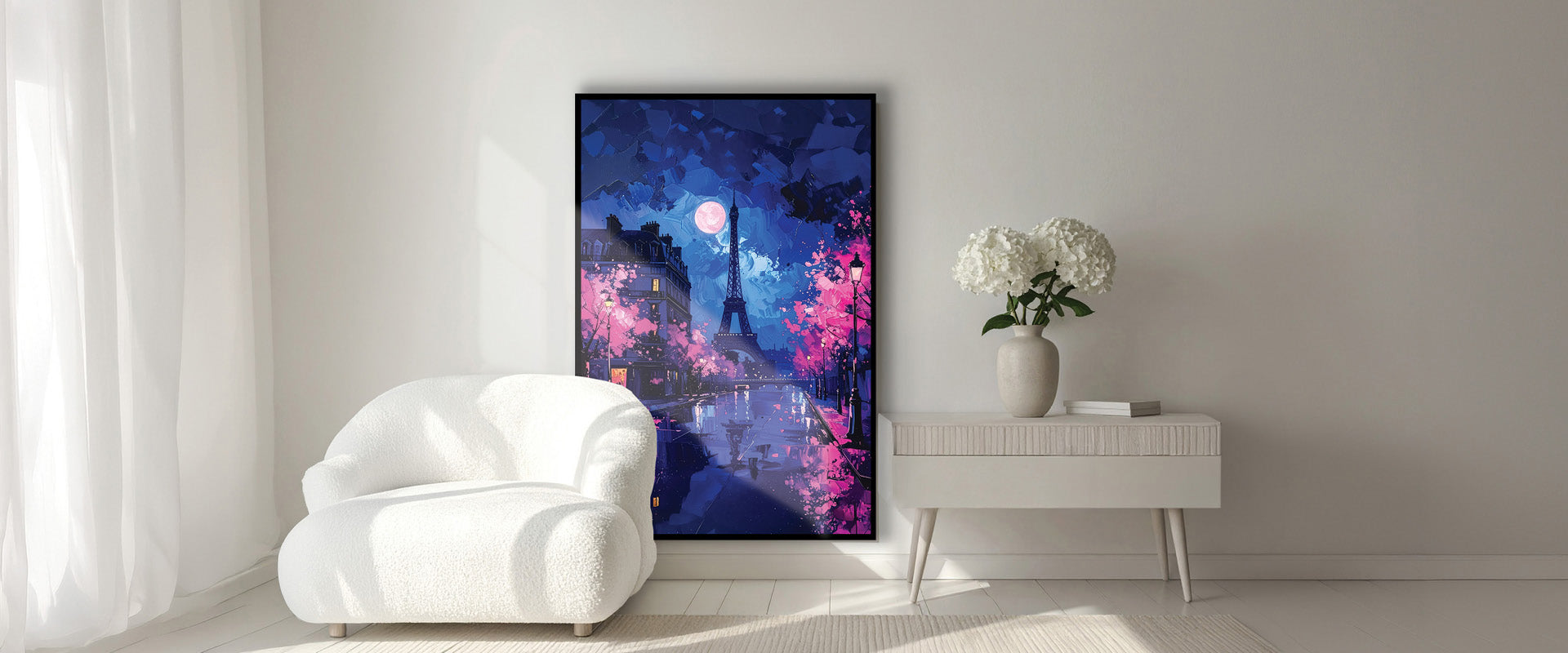 Modern living room with a white armchair, side table, and abstract painting on the wall.